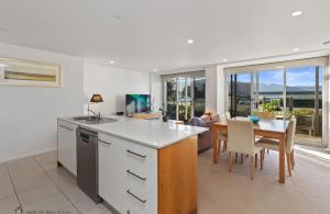 a kitchen and dining room with a table and a dining room at Apollo Blue Ocean View Unit 1-A Free WIFI in Apollo Bay