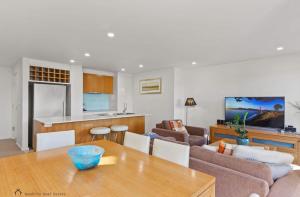 a kitchen and a living room with a table at Apollo Blue Ocean View Unit 1-A Free WIFI in Apollo Bay