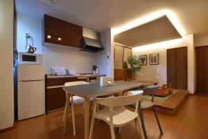a kitchen and dining room with a table and chairs at PrimeRoom別府 TATAMIsuite in Beppu