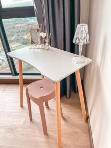 a white table with a chair and a lamp at [Starry Homes @ Green Haven] 2Beds 2Bath+Pool View in Masai +28 photos