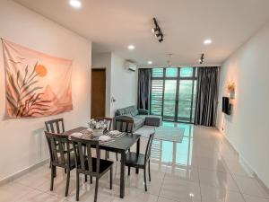 a dining room and living room with a table and chairs at [Starry Homes @ Green Haven] 2Beds 2Bath+Pool View in Masai