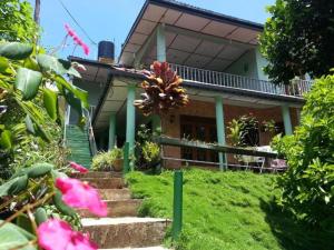 a house with some flowers in front of it at Little Heaven in Ella