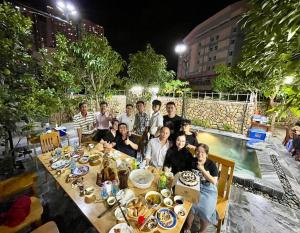 a group of people sitting at a table with food at Garden House Nha Trang in Nha Trang +56 photos