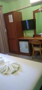 Habitación de hotel con escritorio y toalla en la cama en Amorn Mansion, en Ao Nang Beach