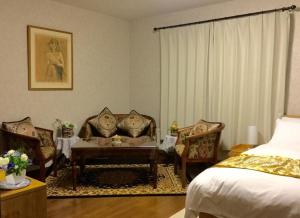 a bedroom with a bed and a table and chairs at Second house TOYA / Vacation STAY 291 in Lake Toya
