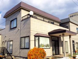 a house with a balcony on top of it at Second house TOYA / Vacation STAY 291 in Lake Toya