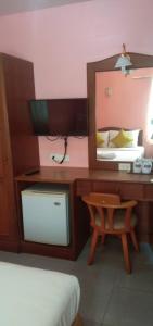 1 dormitorio con escritorio, espejo y silla en Amorn Mansion, en Ao Nang Beach
