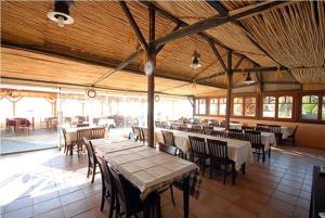 a dining room with tables and chairs in a building at Porto Kalliali in Ouranoupoli