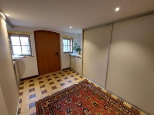 an empty room with a door and a rug at Alte Mühle in Röthis