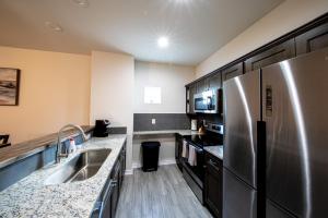 a kitchen with a stainless steel refrigerator and a sink at Lakeshore Retreat in Canyon Lake