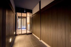 einen Flur mit holzgetäfelten Wänden und einem Gehweg in der Unterkunft Le Studio 五条高倉 in Kyoto