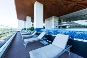 a row of lounge chairs on the roof of a building at Queen Ann Nha Trang Hotel in Nha Trang