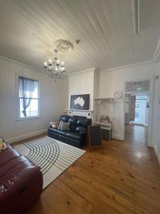 a living room with a couch and a chandelier at Gonow Family Backpackers Hostel in Brisbane