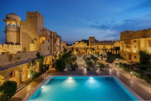 an aerial view of a castle with a swimming pool in front at WelcomHeritage Mohangarh Fort in Jaisalmer