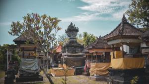 a group of buildings with a statue in the middle at PIMA Homestay in Pesanggaran