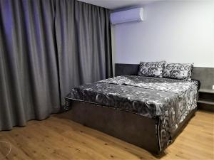 a bedroom with a bed with a gray bedspread at Sofia hotel apartments in Sofia