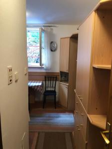 a stairway leading to a kitchen with a chair and a window at BELE STAZE-Brzece,Kopaonik in Brzeće +5 photos