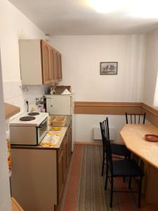 a kitchen with a counter and a table with chairs at BELE STAZE-Brzece,Kopaonik in Brzeće