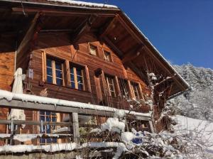 een blokhut in de sneeuw bij Gstaad Paradise View Chalet with Jacuzzi in Rougemont