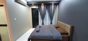 a small bed in a room with a window at Regalia Apartment B-3-1 Kota Samarahan in Kota Samarahan