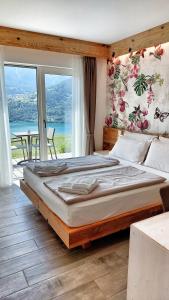 a large bed in a room with a large window at AGRITUR SEDICI - Bed and Breakfast in Tenna 