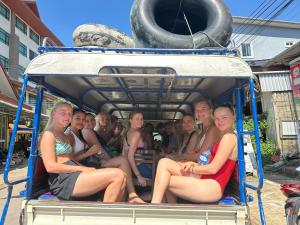a group of people sitting in the back of a truck at Vang Vieng Freedom View Hostel in Vang Vieng