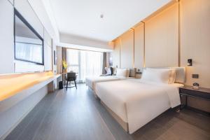 Postel nebo postele na pokoji v ubytování Atour Hotel Xiaolan Zhongshan