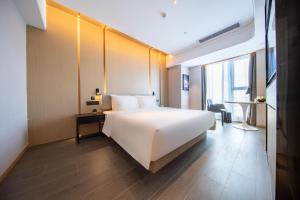 Postel nebo postele na pokoji v ubytování Atour Hotel Xiaolan Zhongshan