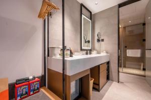 a bathroom with a sink and a shower at Atour Hotel Jiaojiang Taizhou in Taizhou