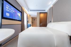 Postel nebo postele na pokoji v ubytování Atour Hotel Xiaolan Zhongshan