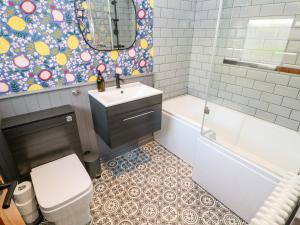 a bathroom with a sink and a toilet and a tub at Cowrie Cottage in North Shields +27 photos
