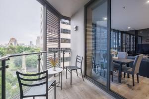 a balcony with a table and chairs and a view at Castlereagh - 2BR Sydney CBD Views Hyde Park Families & Groups in Sydney