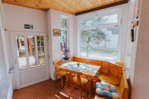 a dining room with a table and chairs and a window at Apartman Marta i soba Maja in Gradište +37 photos