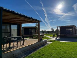 a wooden deck with a table and a pavilion at Sonnenthermen Chalets & Therme included - auch am An- & Abreisetag! in Lutzmannsburg