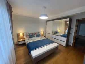a bedroom with a bed and a large mirror at Sunny house in Suceava