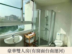 a bathroom with a sink and a shower at New Color River in Tainan