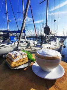 a table with a piece of cake and a cup of coffee at Hotel Galion in Gdańsk