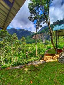 a house with a view of a mountain at Eco Wild Glamping Bambarakanda 