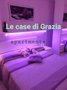 a purple room with a bed with purple lighting at Le case di Grazia in Gaeta