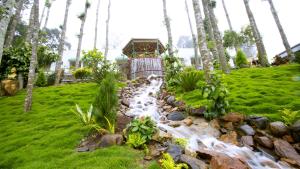 una cascata in un giardino con palme di Happy Nest Yercaud a Yercaud