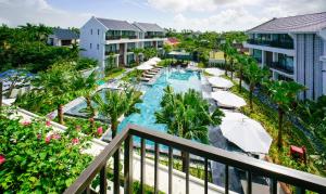 an aerial view of a resort pool with umbrellas at SENVILA Boutique Resort & Spa in Hoi An