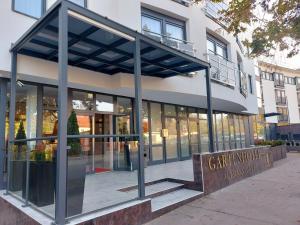a building with a sign in front of it at Gartenhotel Altmannsdorf in Vienna