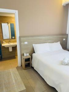 a hotel room with a bed and a sink at Hotel Villa Sveva in Cagliari