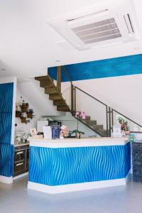 a kitchen with a blue and white counter and stairs at Hotel Villa Sveva in Cagliari