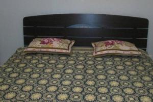 a bed with two pillows on top of it at Mae Phim Villa BR64 by Sun4U in Ban Bua Phut