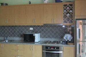 a kitchen with a microwave and a stove and a refrigerator at Mae Phim Villa BR64 by Sun4U in Ban Bua Phut