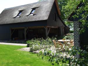 a barn with two windows on the roof at Erfgoed & Logies Den Heijkant in Moergestel