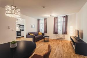 a living room with a table and a couch at Ferienwohnungen und Boardinghouse Heimbach in Lahr in Lahr