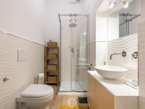a bathroom with a toilet and a sink and a shower at Casa Aura - City Centre in Oristano