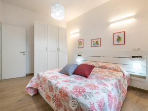 a bedroom with a bed with two pillows on it at Casa Aura - City Centre in Oristano
